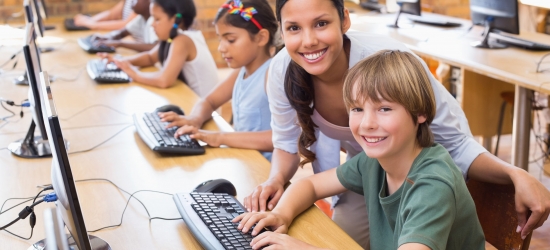 38077929 - cute pupils in computer class with teacher at the elementary school